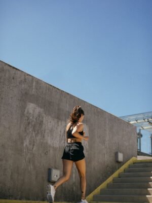 Woman in Black Tank Top and Black Shorts Running